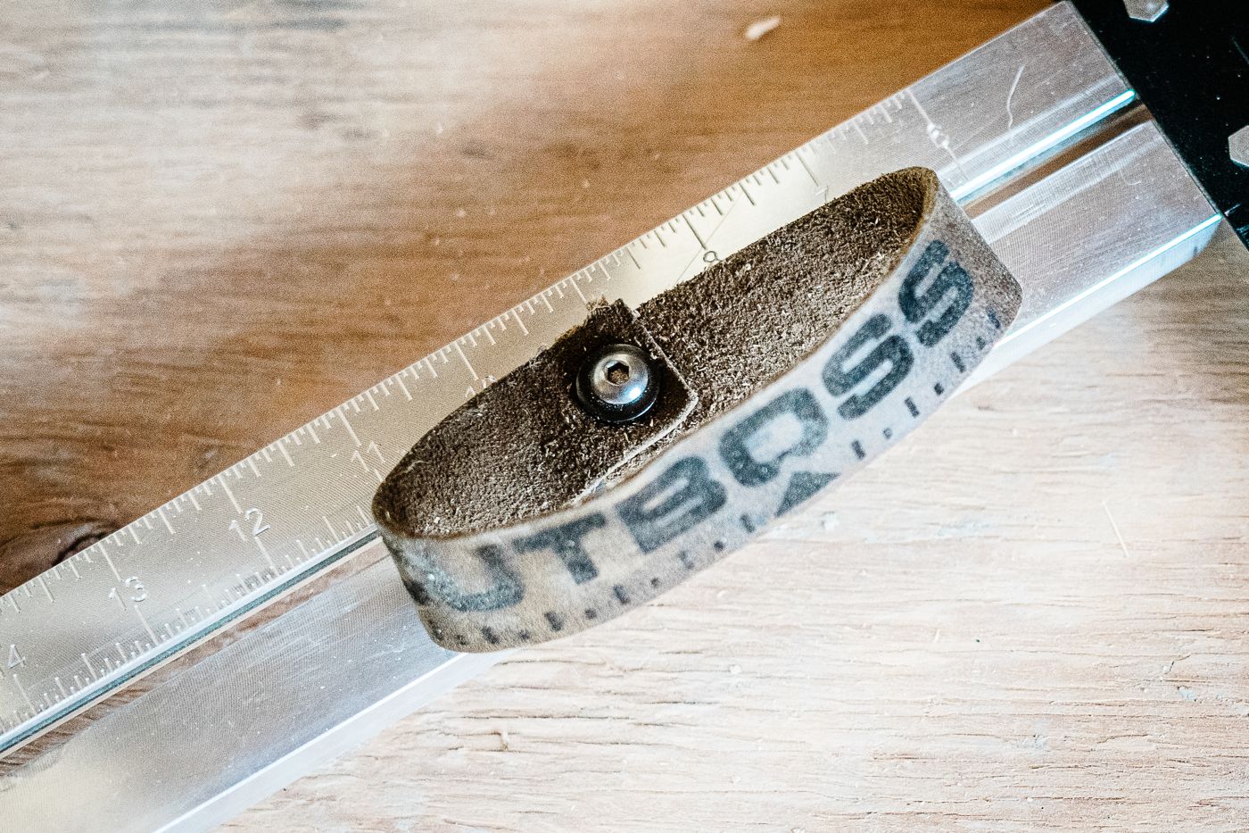 Leather strap branded with a logo, fitted on the CutBoss
